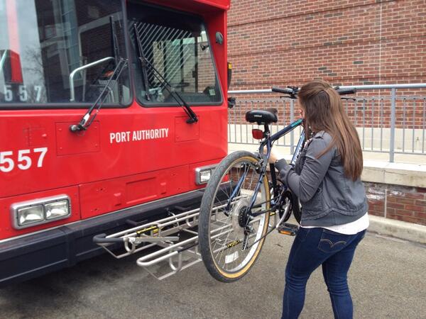 Sarah, a Chatham College for Women student and Bike PGH intern, learning how to use the bike racks on a Pittsburgh Port Authority bus!
